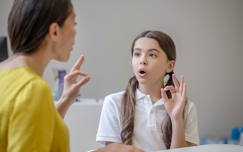 Speech therapist helping a child