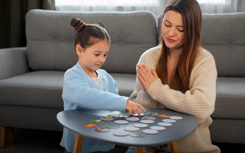 Therapist using flashcards with child